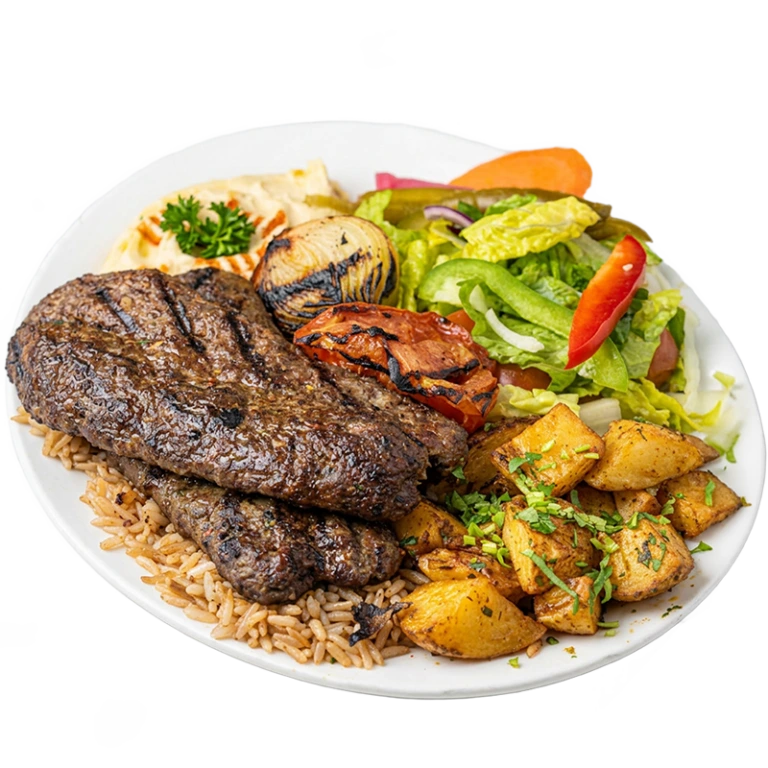Kafta kabab platter with grilled seasoned ground beef skewers, rice, roasted potatoes, fresh salad and garlic sauce from Shawarma Palace